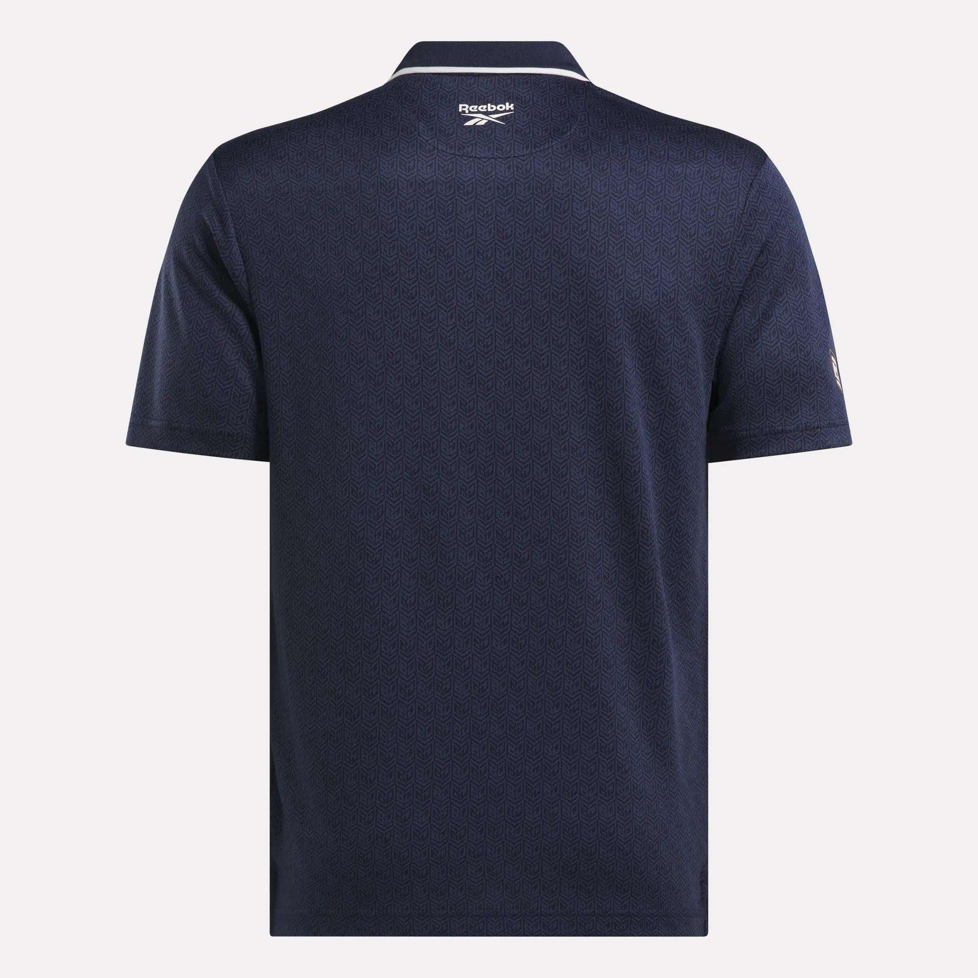 Back view of the Men's BDC Signature Polo Shirt by Reebok in navy blue, featuring RBK-DRY fabric, a subtle textured pattern, a collar, and the Reebok logo below the neckline.