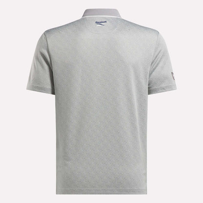 Back view of the Men's BDC Signature Polo Shirt by Reebok in light gray, featuring short sleeves, a subtle geometric pattern, and logos near the collar and left sleeve. Made with RBK-DRY fabric for comfort on and off the course.