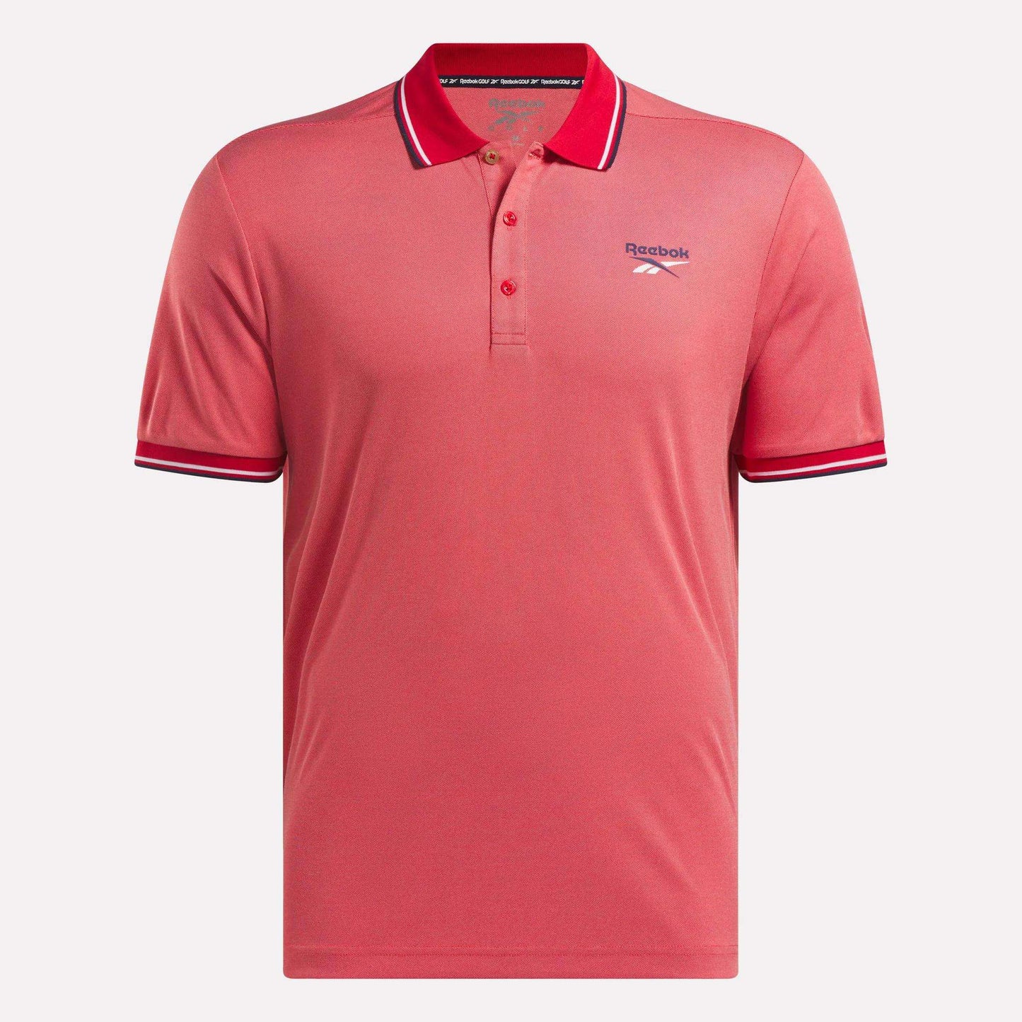 The Men's Country Club Oxford Pique Polo Shirt by Reebok is coral pink with a collar, three buttons, white and navy striped collar and sleeve cuffs, and an embroidered Reebok logo on the left chest.