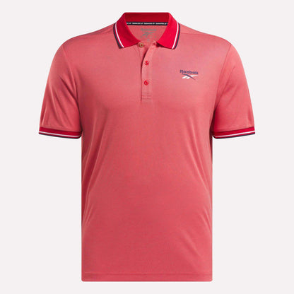 The Men's Country Club Oxford Pique Polo Shirt by Reebok is coral pink with a collar, three buttons, white and navy striped collar and sleeve cuffs, and an embroidered Reebok logo on the left chest.