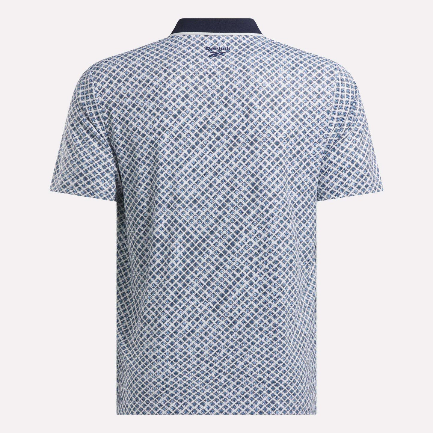 Back view of the Men’s Sublimation Print Shirt by Reebok, featuring a sweat-wicking fabric, blue and white diamond pattern, dark collar, and the Reebok logo at the upper back below the collar.