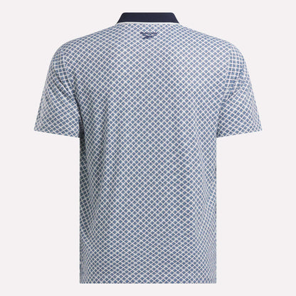 Back view of the Men’s Sublimation Print Shirt by Reebok, featuring a sweat-wicking fabric, blue and white diamond pattern, dark collar, and the Reebok logo at the upper back below the collar.