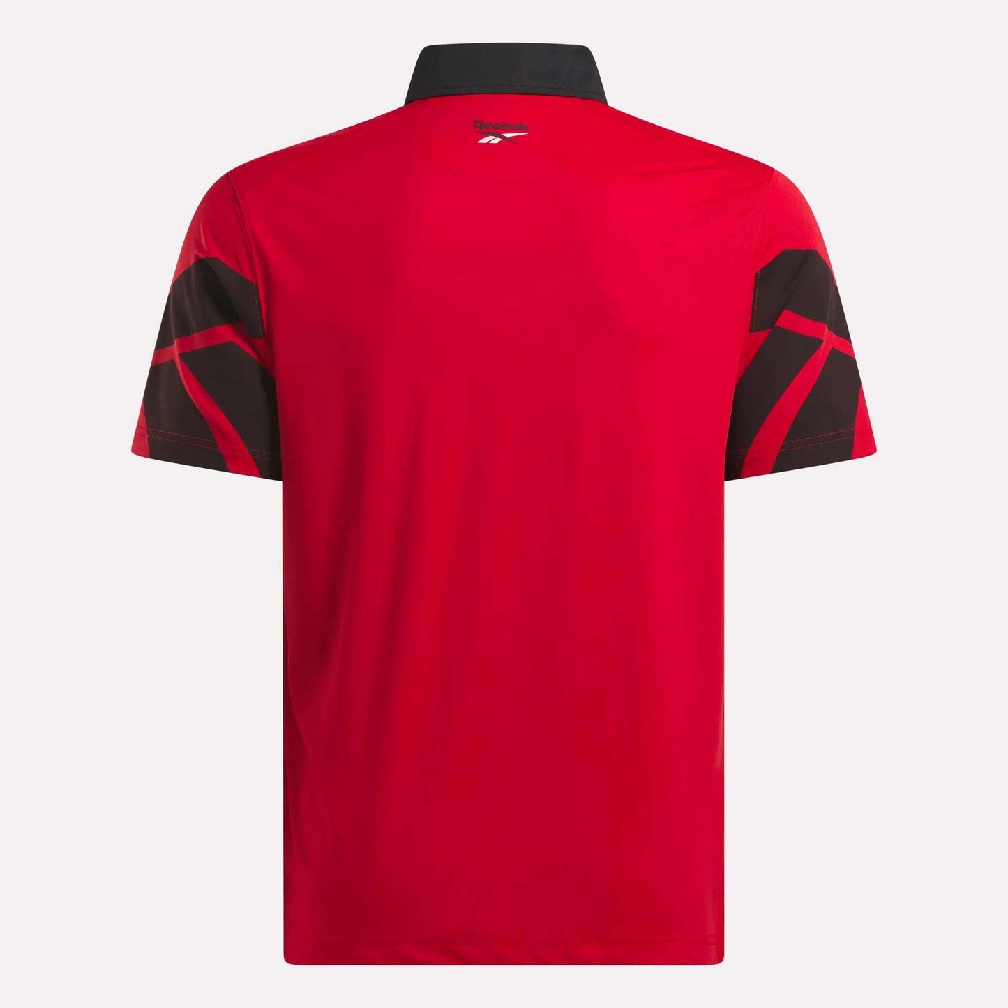 Back view of the Reebok Men's Signature Vector Colorblocked Polo Shirt in red, featuring short sleeves, a black collar, black geometric sleeve patterns, moisture-wicking fabric, and UPF 30+ protection.