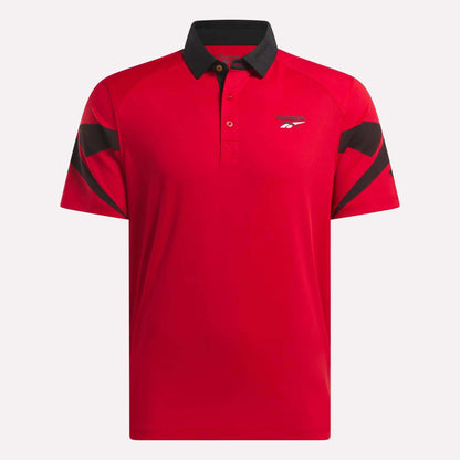 The Reebok Men's Signature Vector Colorblocked Polo Shirt is a red, moisture-wicking short-sleeve golf polo with black collar and sleeve accents and a small logo on the left chest.