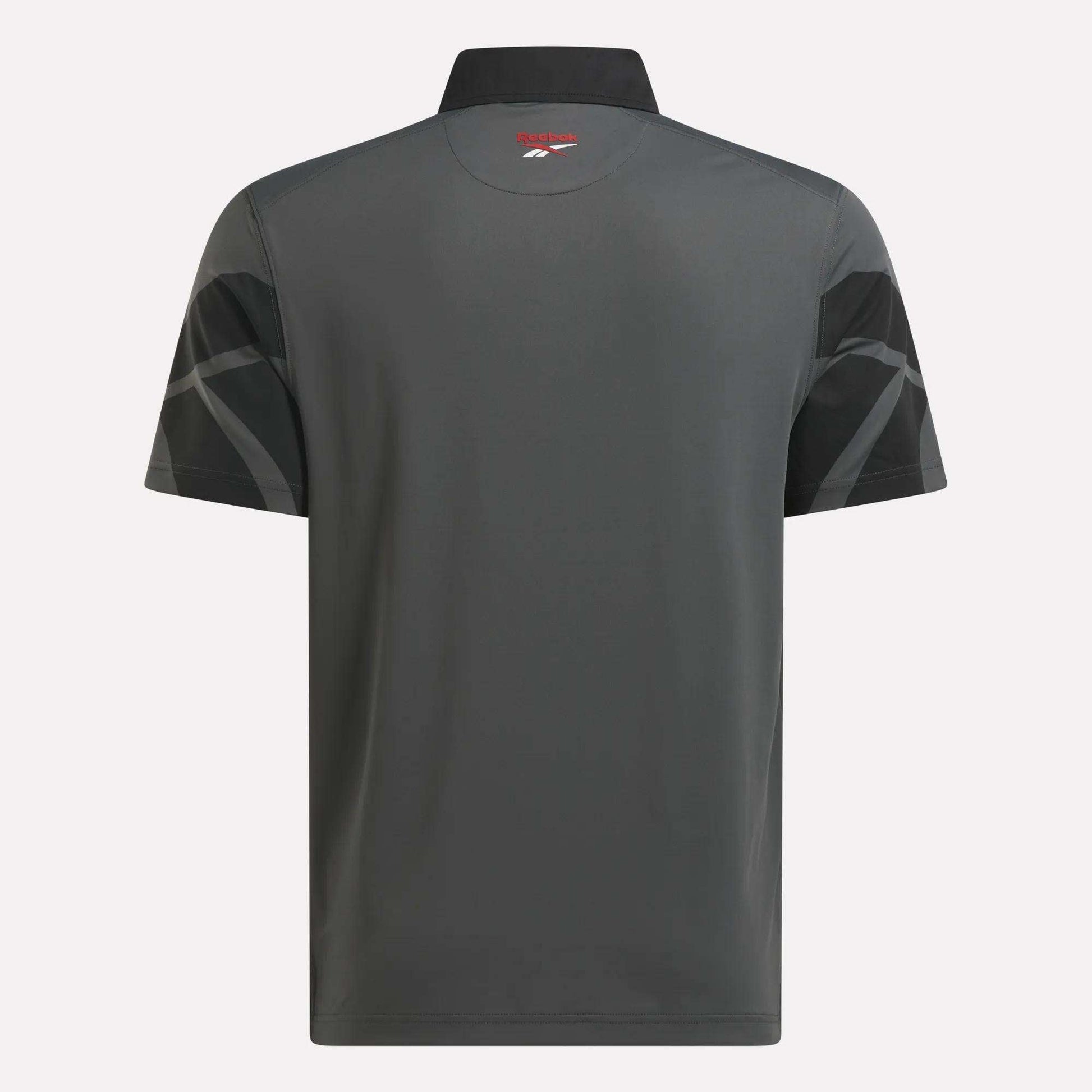 Back view of the Reebok Men's Signature Vector Colorblocked Polo Shirt, showing short sleeves, black geometric patterns, a small red and white logo below the collar, and RBK-DRY fabric for comfort on or off the course.