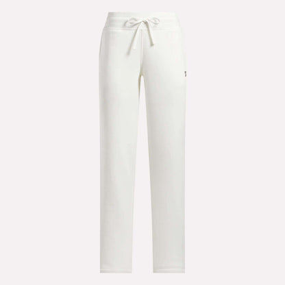 Reebok Women's Cozy Classic Sweatpants in white cotton blend featuring a drawstring waistband, straight-leg fit, and a small logo on the upper left thigh. Shown against a plain, light-colored background.