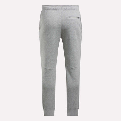 Back view of Reebok Men's Motion Joggers in light gray featuring a slim fit, elastic waistband, two side pockets, a zippered back pocket, and ribbed ankle cuffs.
