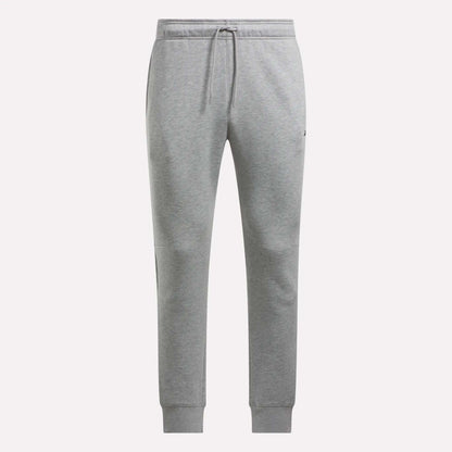 Reebok Men's Motion Joggers in light grey feature a slim fit, elastic waistband with front drawstring, side pockets, and ribbed cuffs, shown on a plain white background.