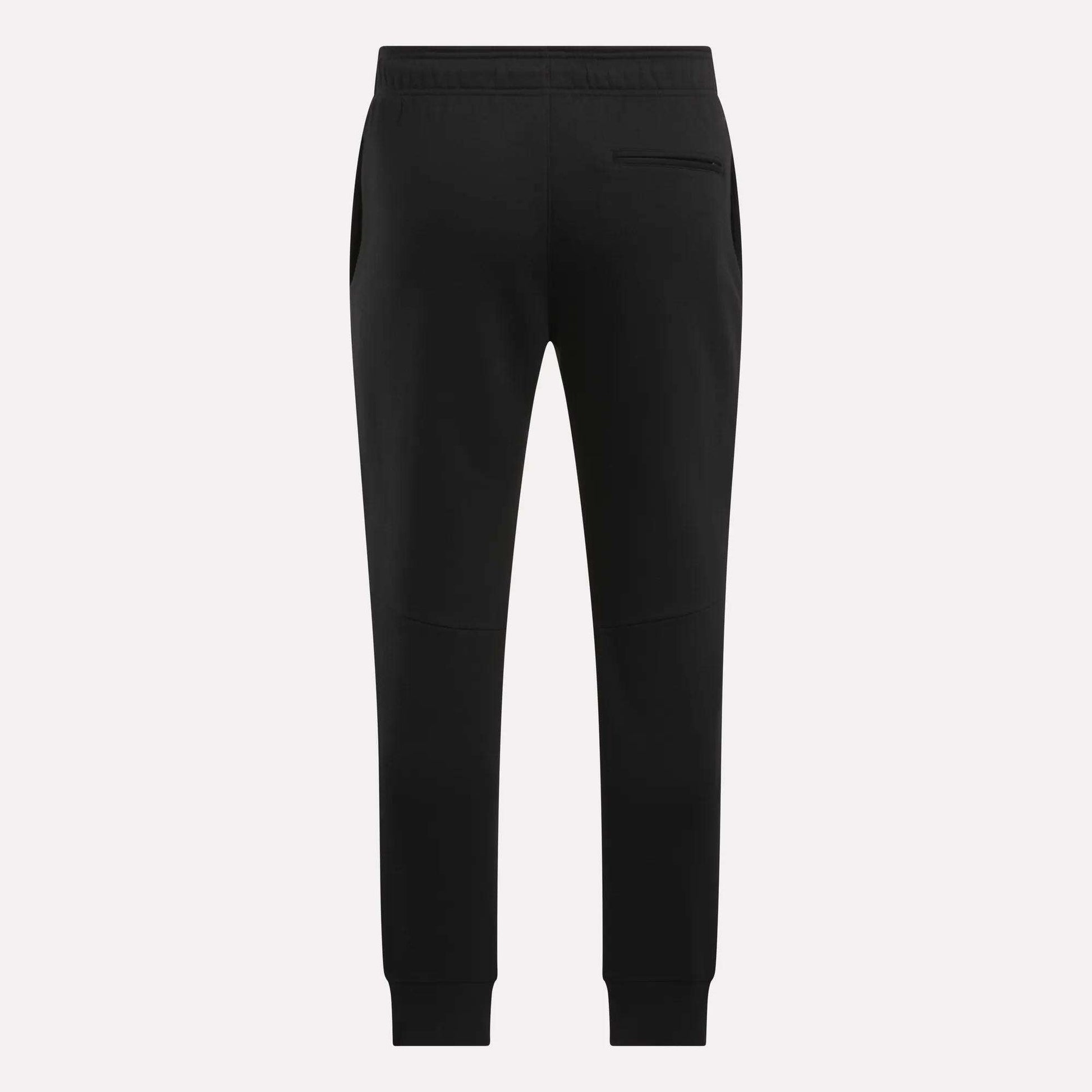 The Reebok Men's Motion Joggers in black slim fit are shown from the back, featuring an elastic waistband, side pockets, a single right back pocket, and tapered legs with ankle cuffs.