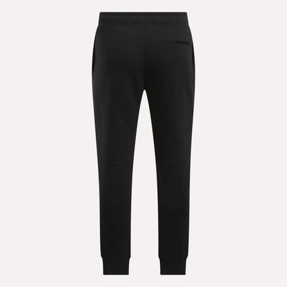The Reebok Men's Motion Joggers in black slim fit are shown from the back, featuring an elastic waistband, side pockets, a single right back pocket, and tapered legs with ankle cuffs.