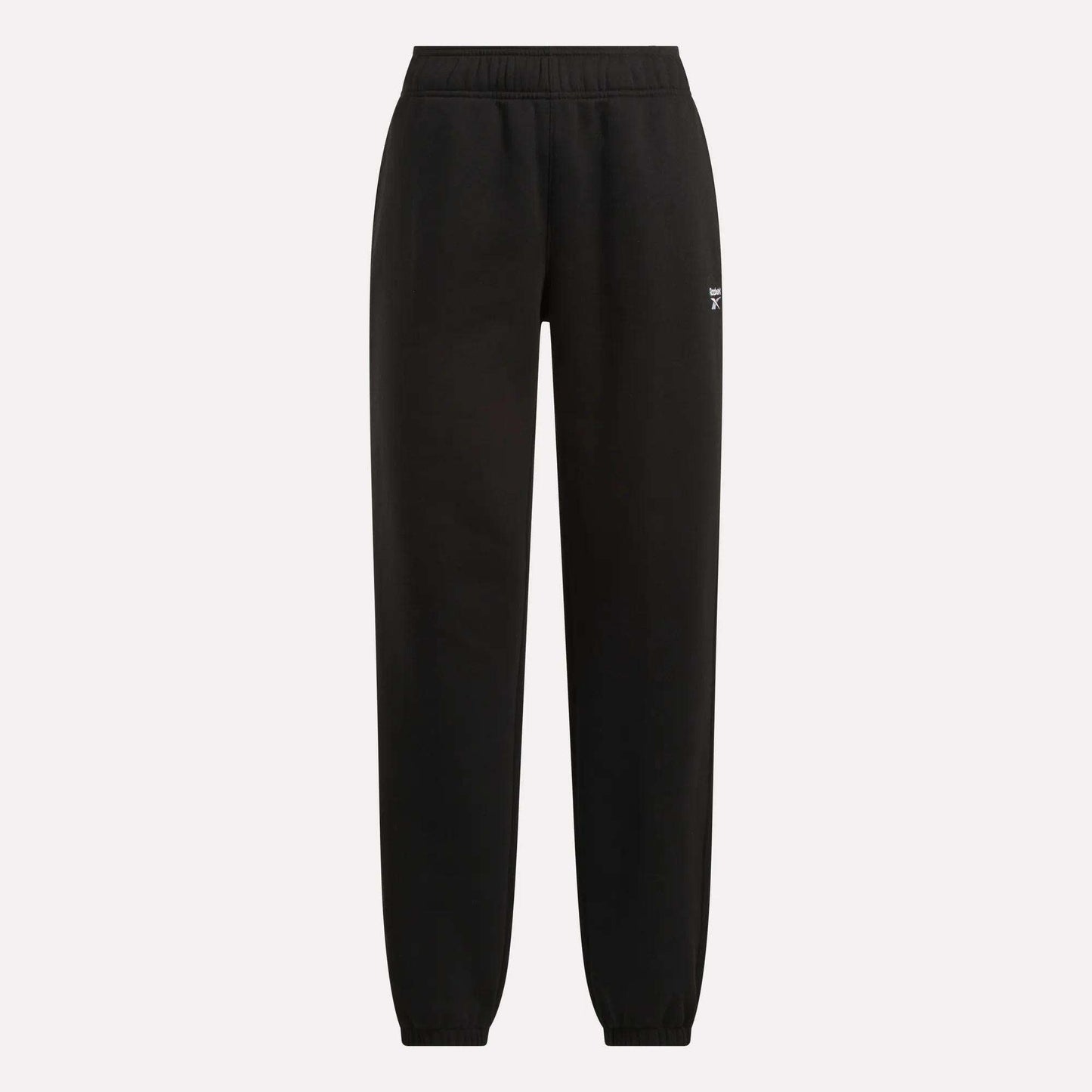 Reebok Women's Medium Vector Sweatpants in black with an elastic waistband and cuffed ankles, shown on a plain light background. Crafted from soft cotton-blend fabric with a small white Reebok logo on the upper left thigh.