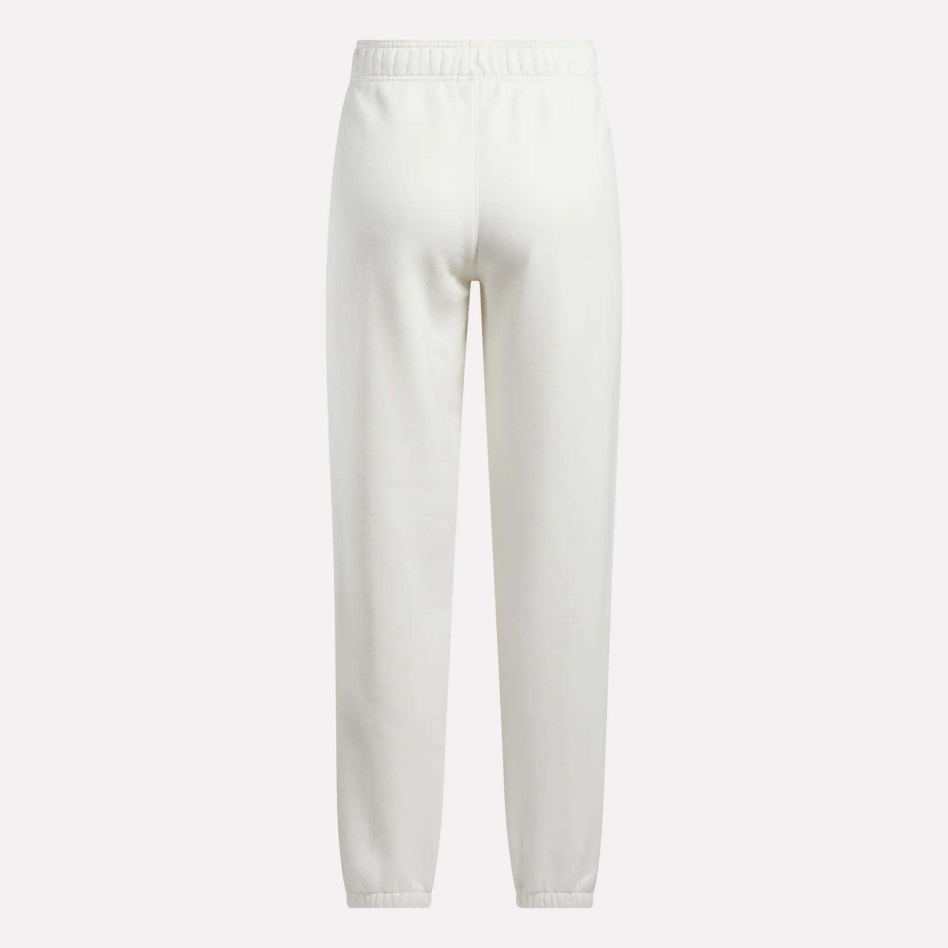 Back view of Reebok Women's Medium Vector Sweatpants in plain white, made from a comfortable cotton-blend fabric with an elastic waistband and ankle cuffs, shown against a white background.