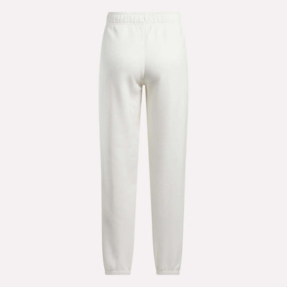 Back view of Reebok Women's Medium Vector Sweatpants in plain white, made from a comfortable cotton-blend fabric with an elastic waistband and ankle cuffs, shown against a white background.