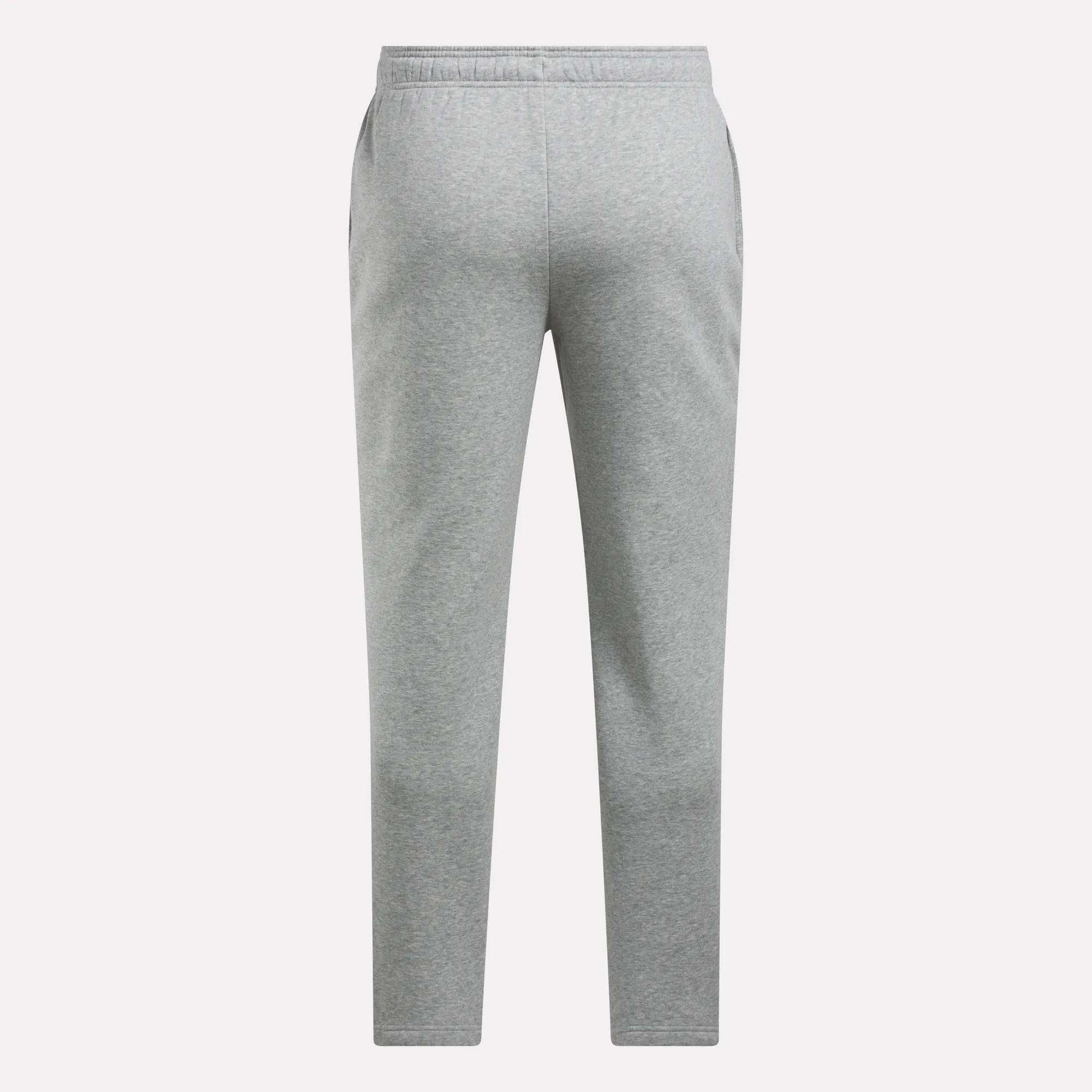 The Reebok Men's Patent Pants feature a plain light gray design with an adjustable waistband and straight legs, displayed against a white background.