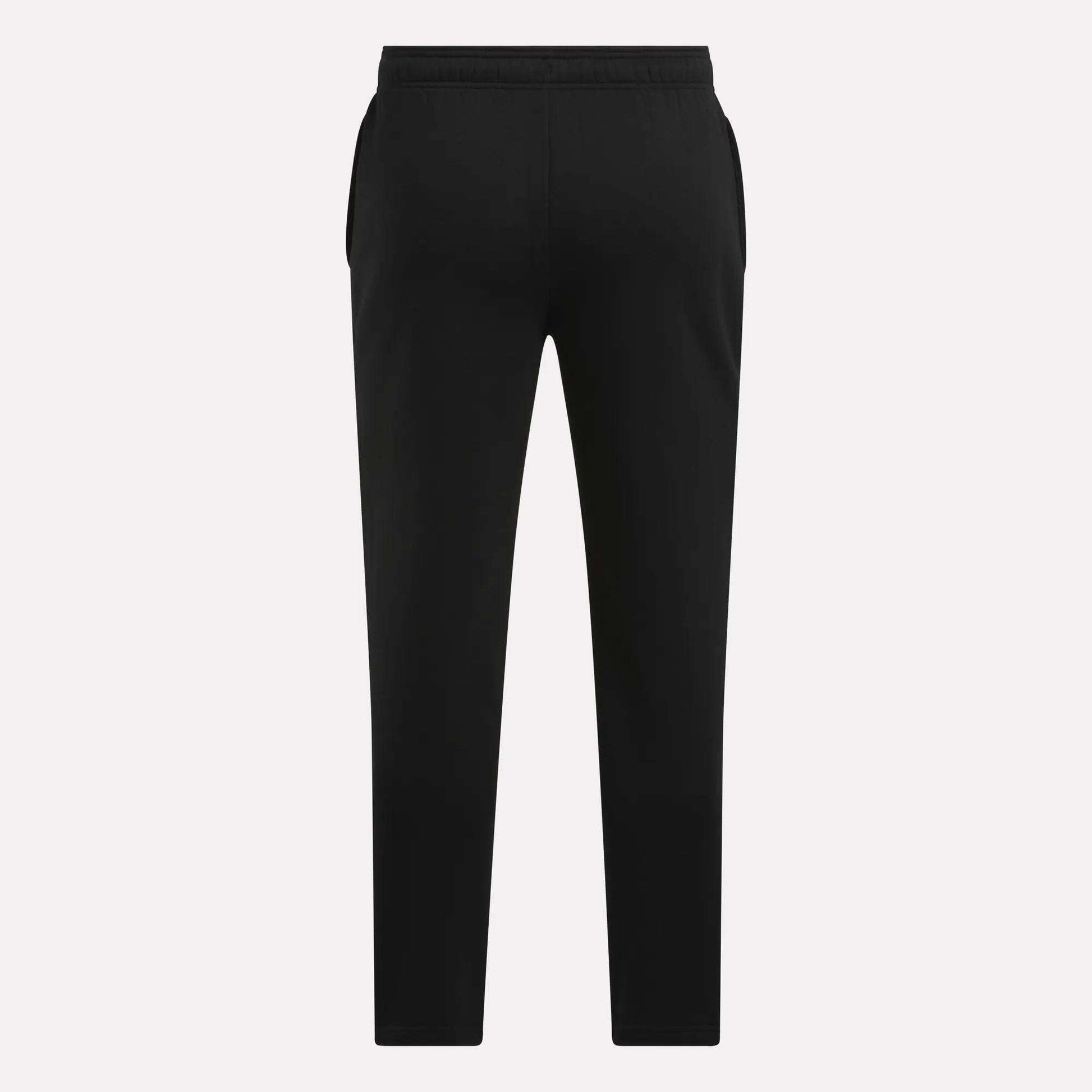 Men's Patent Pants by Reebok in black, featuring a slim fit, elastic waistband, and tapered legs, shown from the back against a plain light background.