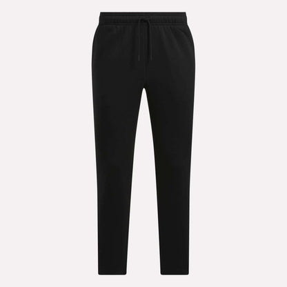 Reebok Men's Patent Pants in black, with an adjustable waistband, straight legs, and side pockets, shown on a plain white background.