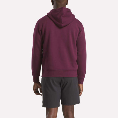 A man is seen from behind wearing the Reebok Men's Finisher Hoodie in maroon with black shorts, standing against a plain white background.