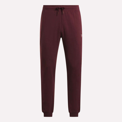 Reebok Men's French Terry Logo Joggers in maroon, featuring a drawstring waist, ribbed cuffs, and a small white logo on the left hip, shown against a plain light background.