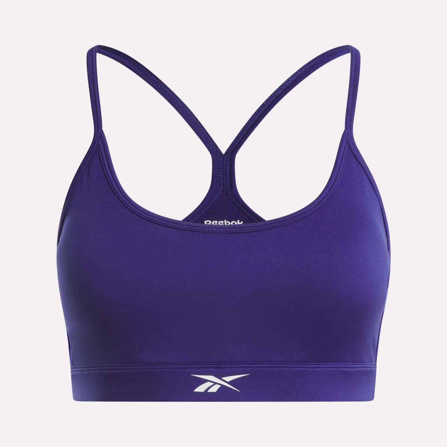 The Reebok Women's Strappy Sports Bra features a racerback design with spaghetti straps and the iconic logo on the front band. Made from quick-drying fabric, it's ideal for medium-impact workouts.