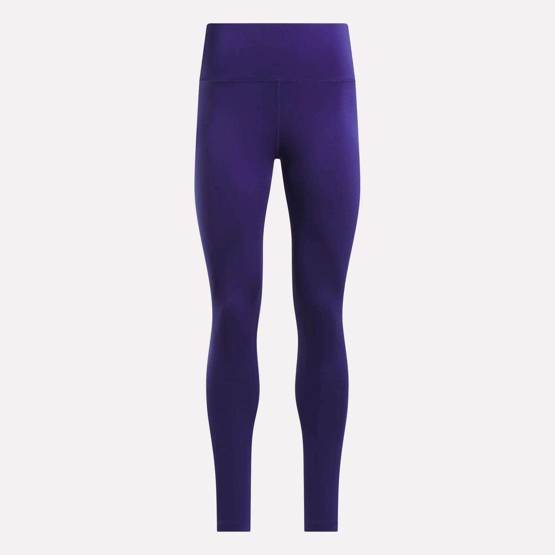 Front view of Reebok Women's High-Rise Leggings in solid dark purple, featuring full-length coverage and crafted from RBK-DRY fabric, displayed against a plain white background.