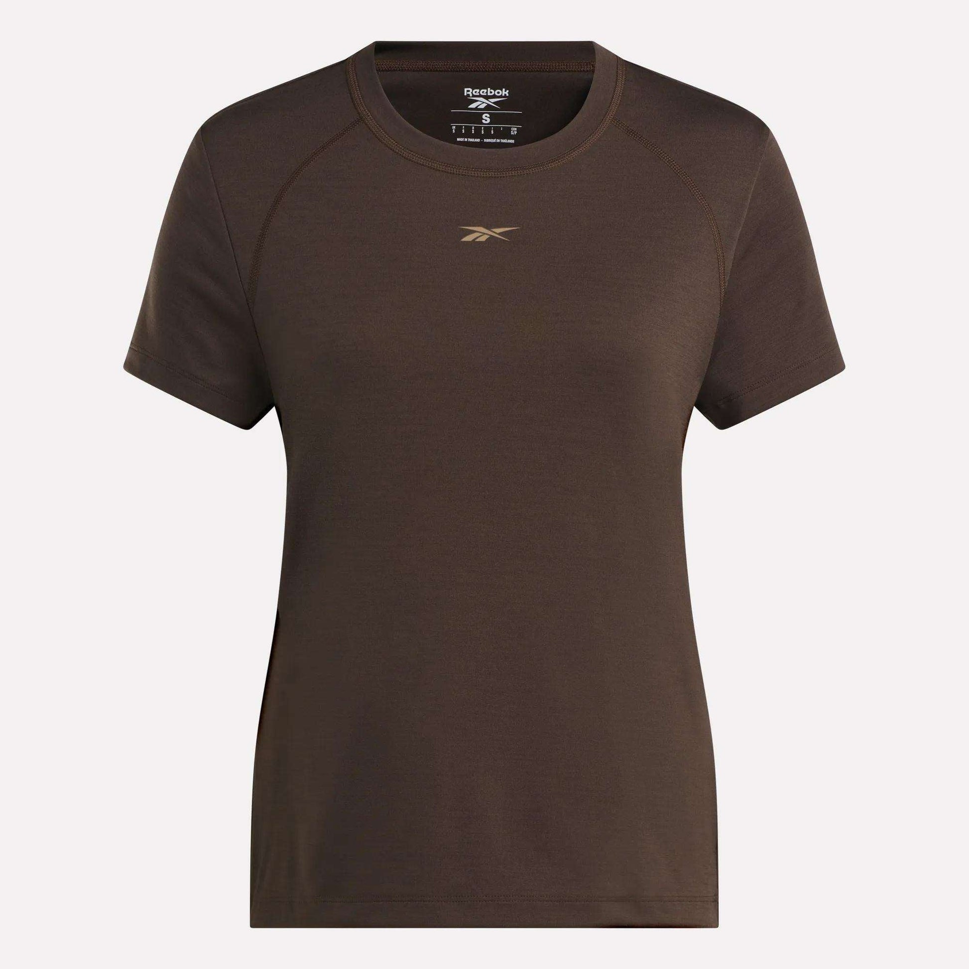The Women's Training T-Shirt by Reebok showcases RBK-DRY technology, a small gold logo on the chest, and comes in plain brown. Displayed against a light background.