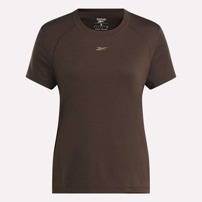 The Women's Training T-Shirt by Reebok showcases RBK-DRY technology, a small gold logo on the chest, and comes in plain brown. Displayed against a light background.