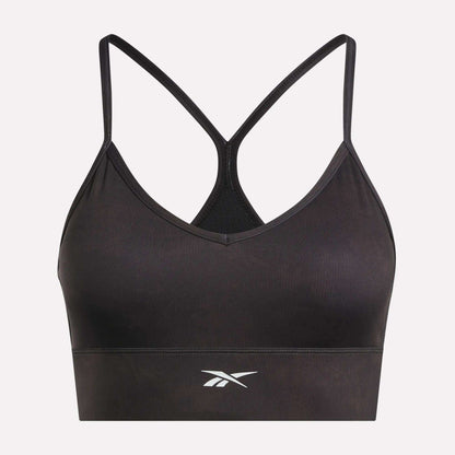 The Reebok Women's Printed Tri-Back Sports Bra features thin racerback straps and a white Reebok logo on the front, shown against a plain white background. Designed with sweat-wicking fabric, this workout bra keeps you comfortable and dry during your most intense sessions.