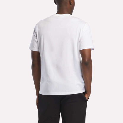 A person wearing a Reebok Men's Logo T-Shirt in white and black pants, shown from the back against a light background—perfect for everyday wear.