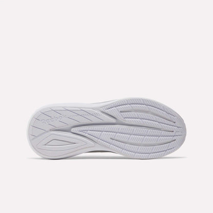 The image shows the bottom view of a white Women's Viva Speed Shoe sole by Reebok, featuring curved grooves and traction patterns, along with a cushioned midsole designed for all-day comfort and breathability.