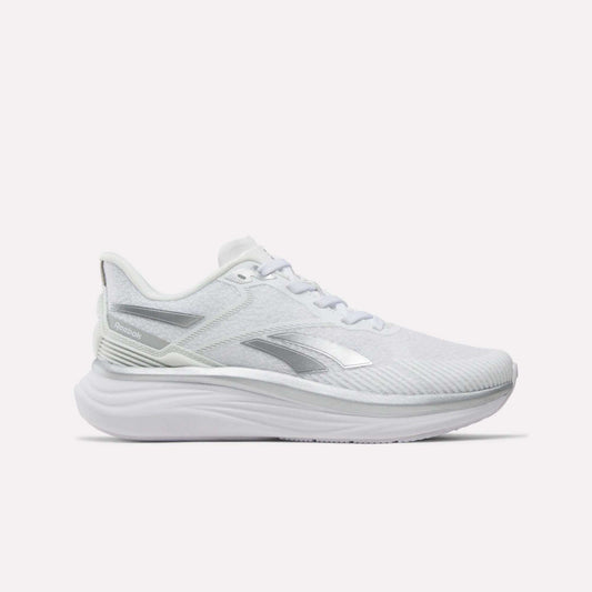 The Reebok Women's Viva Speed Shoes in White/White/Grey feature a thick, sculpted sole and a breathable mesh upper with subtle silver accents. Displayed against a plain light background, these athletic running shoes are the perfect choice for those seeking both style and comfort.