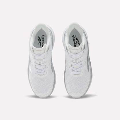Top view of a pair of white Women's Viva Speed Shoes by Reebok with laces, featuring a cushioned midsole for added comfort, placed side by side on a plain white background.