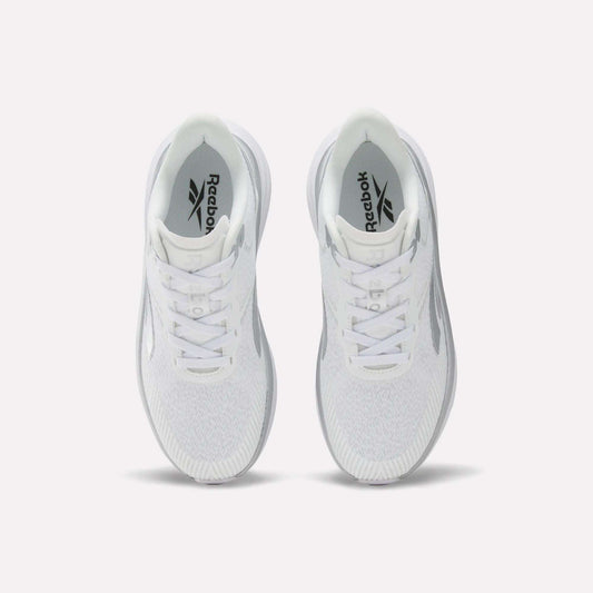Top view of a pair of white Women's Viva Speed Shoes by Reebok with laces, featuring a cushioned midsole for added comfort, placed side by side on a plain white background.