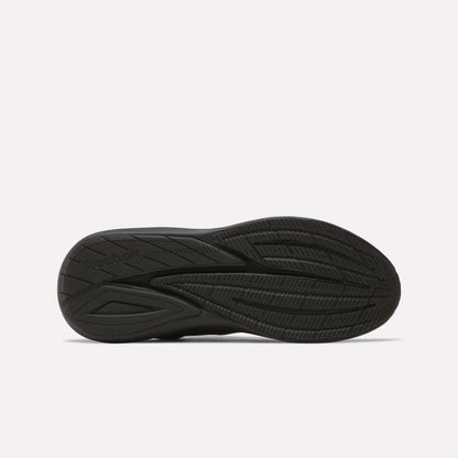 The image displays the black rubber outsole of Men's Viva Speed Shoes by Reebok, highlighting textured grooves and patterns for traction, set against a plain white background.