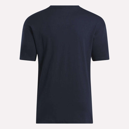 The Reebok Men's Stacked Vector T-Shirt, made from soft cotton in plain navy blue, is displayed from the back against a light background.