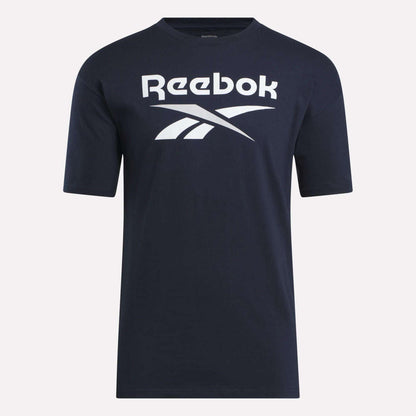 The Reebok Men's Stacked Vector T-Shirt is a navy blue cotton tee with short sleeves, featuring a bold white Reebok logo and text on the chest—ideal for everyday comfort.