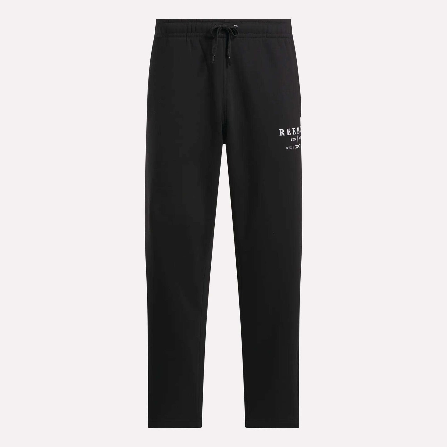 Men's International Straight Leg Pants by Reebok in black plush fleece, designed in a relaxed jogger style with a drawstring waist and straight legs. A small white Reebok logo appears on the upper left thigh, and the open hem pants are displayed against a plain light gray background.