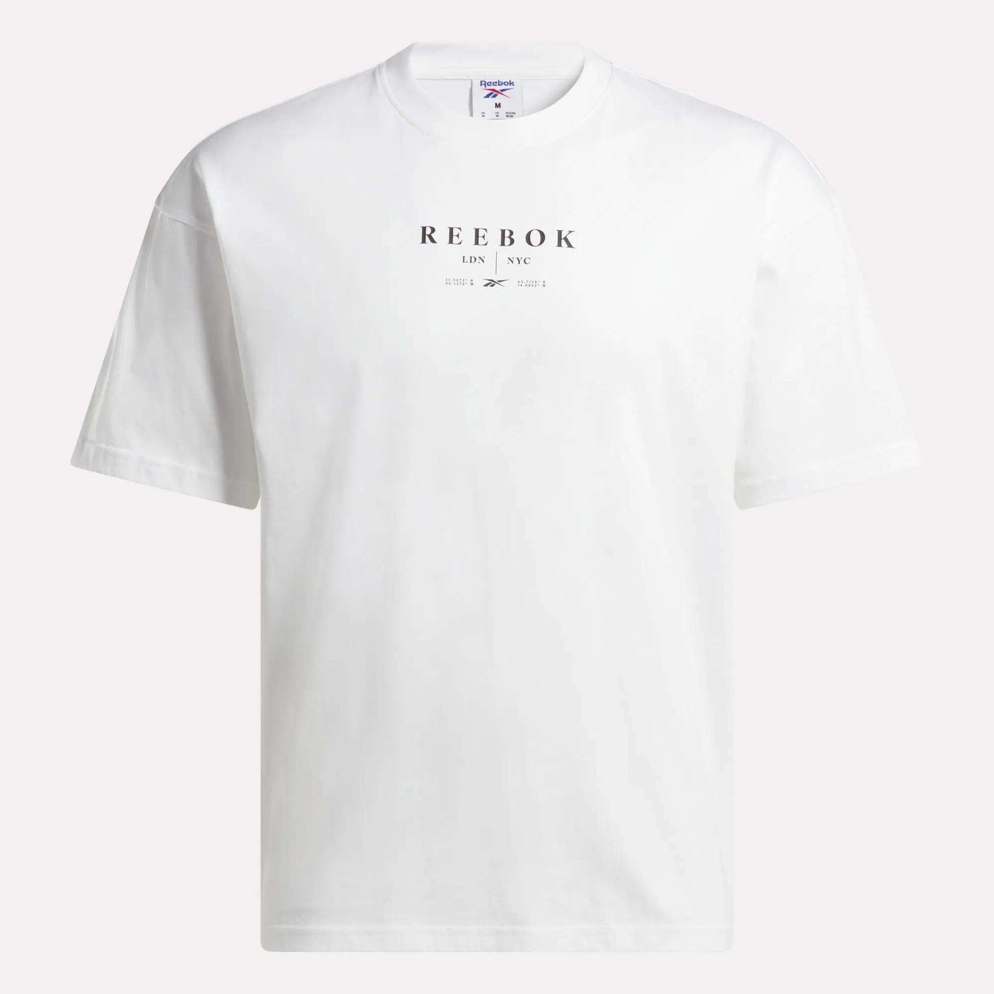 The Reebok Men's International T-Shirt is a versatile, short-sleeve tee crafted from soft cotton jersey in plain white, featuring bold black "REEBOK LDN NYC" lettering on the front—ideal for casual wear.