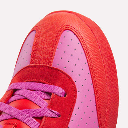 Close-up of the Reebok x BBC Board Flip Skate Shoes, featuring a bold red and pink colorway with pink laces, perforated pink leather, and red suede and fabric accents—ideal for standout street style.