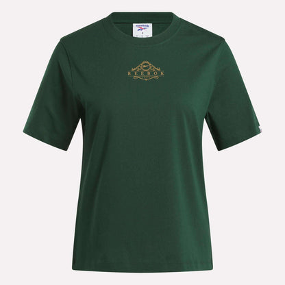 The Women's Fitted Graphic T-Shirt by Reebok features a plain dark green design with short sleeves, a crew neckline, and a small gold Reebok logo with a decorative detail on the chest. Made from soft cotton, this durable graphic tee delivers comfort and classic everyday style.