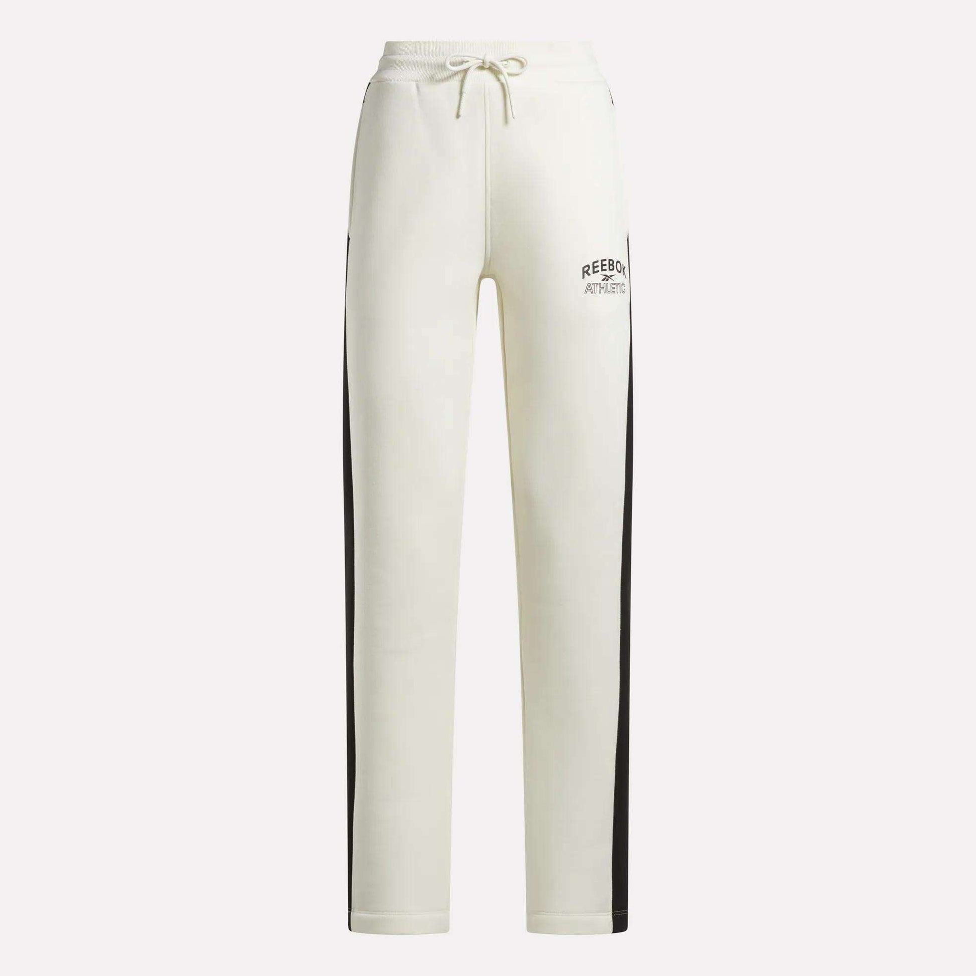 Crafted by Reebok, the Women’s Fleece Straight Leg Pants feature a crisp white design with black side stripes, an elastic waistband with drawstring closure, and Reebok Athletic branding on the left thigh. These cozy fleece pants are perfect for lounging in style against a plain background.