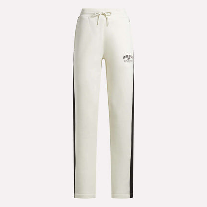 Crafted by Reebok, the Women’s Fleece Straight Leg Pants feature a crisp white design with black side stripes, an elastic waistband with drawstring closure, and Reebok Athletic branding on the left thigh. These cozy fleece pants are perfect for lounging in style against a plain background.