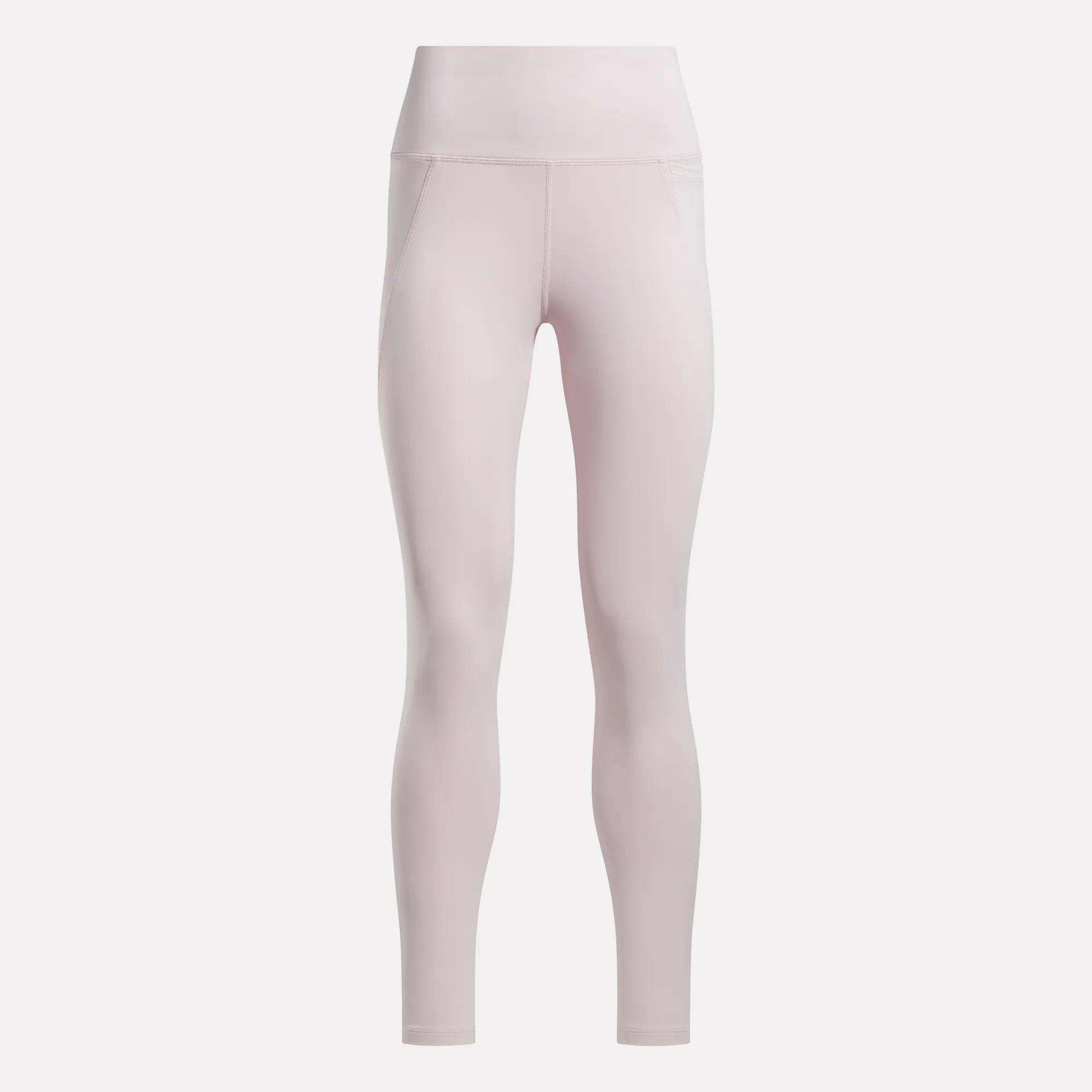 Light pink Reebok Women's High-Rise Leggings constructed from RBK-DRY performance fabric, featuring a smooth, seamless design and fitted, full-length silhouette with no visible branding. Shown against a plain white background.