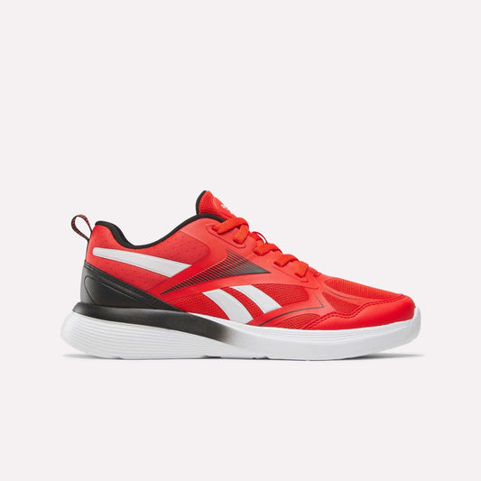 The Reebok Rush Runner 6.0 Running Shoes for Big Kids in Rival Red/Black/Ftwr White feature red uppers, white accents, a white EVA midsole, black heel detail, and red laces, displayed on a plain light background.