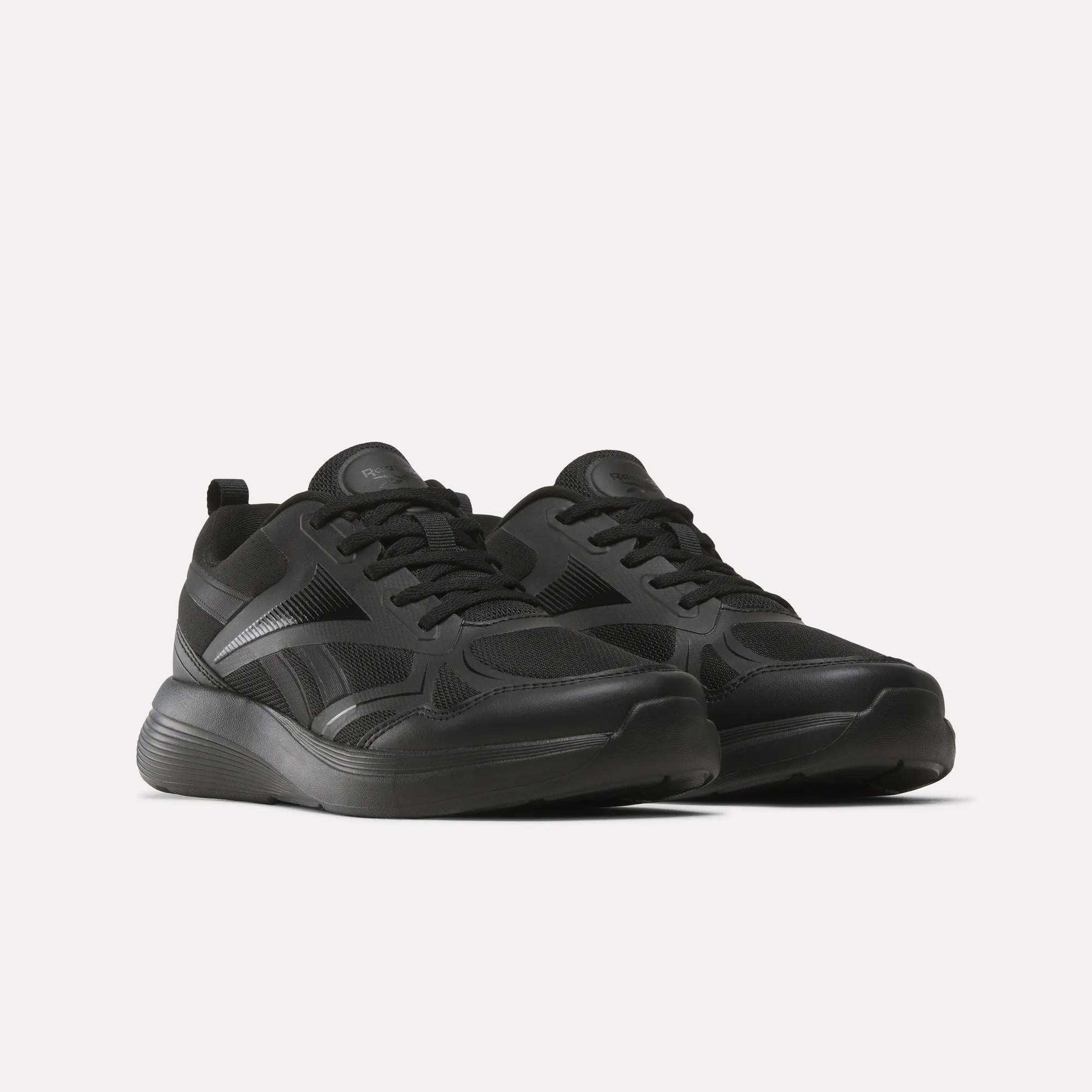 The Reebok Rush Runner 6.0 Running Shoes for big kids are sleek black athletic shoes with mesh panels, thick rubber soles, and an EVA midsole, shown side by side on a plain white background.