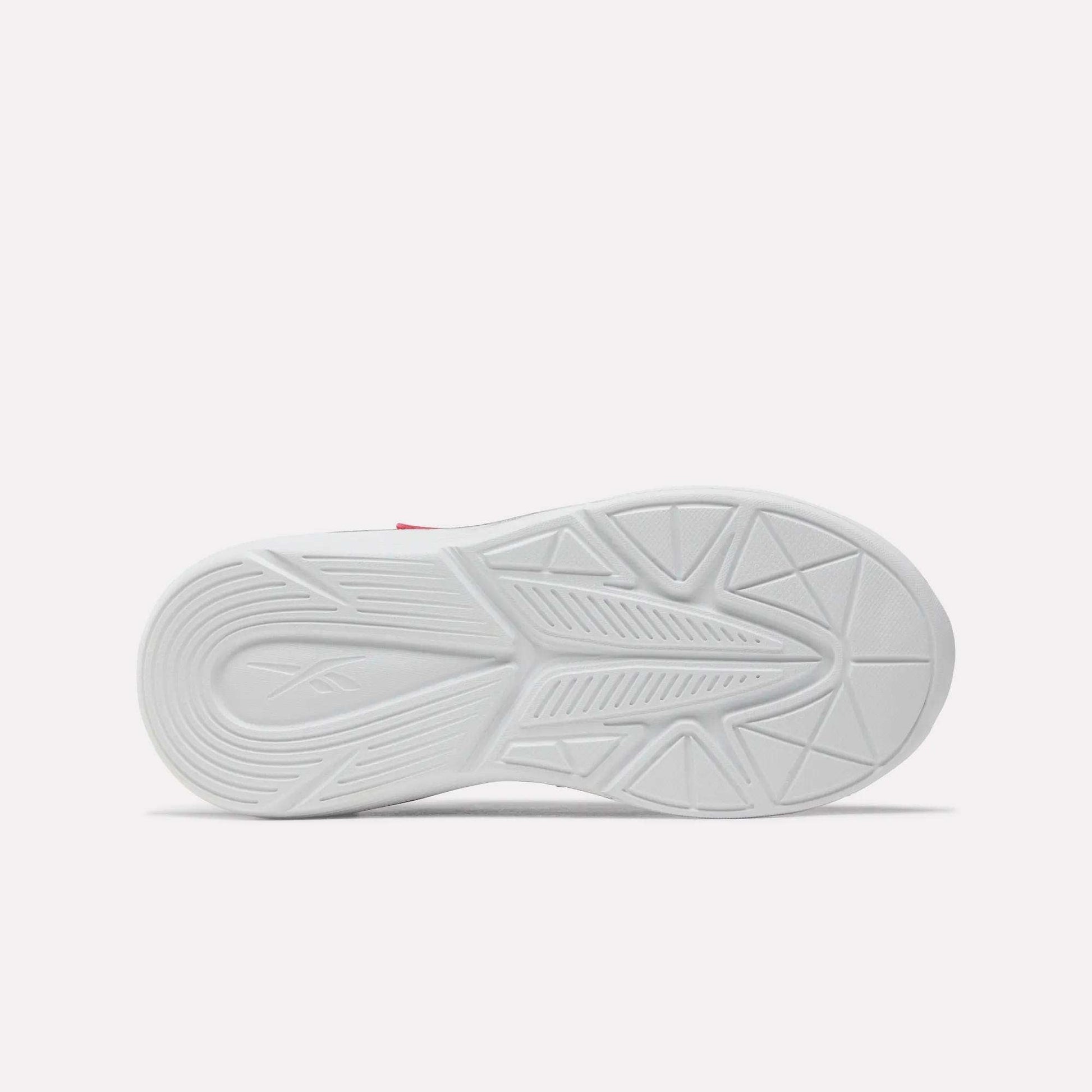 Bottom view of the Rush Runner 6.0 Elastic Lace Top Strap Running Shoes for little kids by Reebok, showing a white rubber sole with geometric tread patterns and a subtle logo on the heel, inspired by classic Reebok designs against a plain light background.