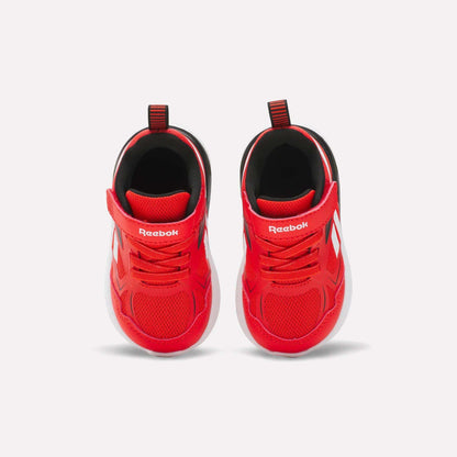 The Reebok Rush Runner 6.0 Gore Lace Top Strap Running Shoes for baby and toddler boys feature bright red mesh uppers, white accents, Velcro straps, pull tabs, and EVA-cushioned white soles, shown from above on a plain white background.