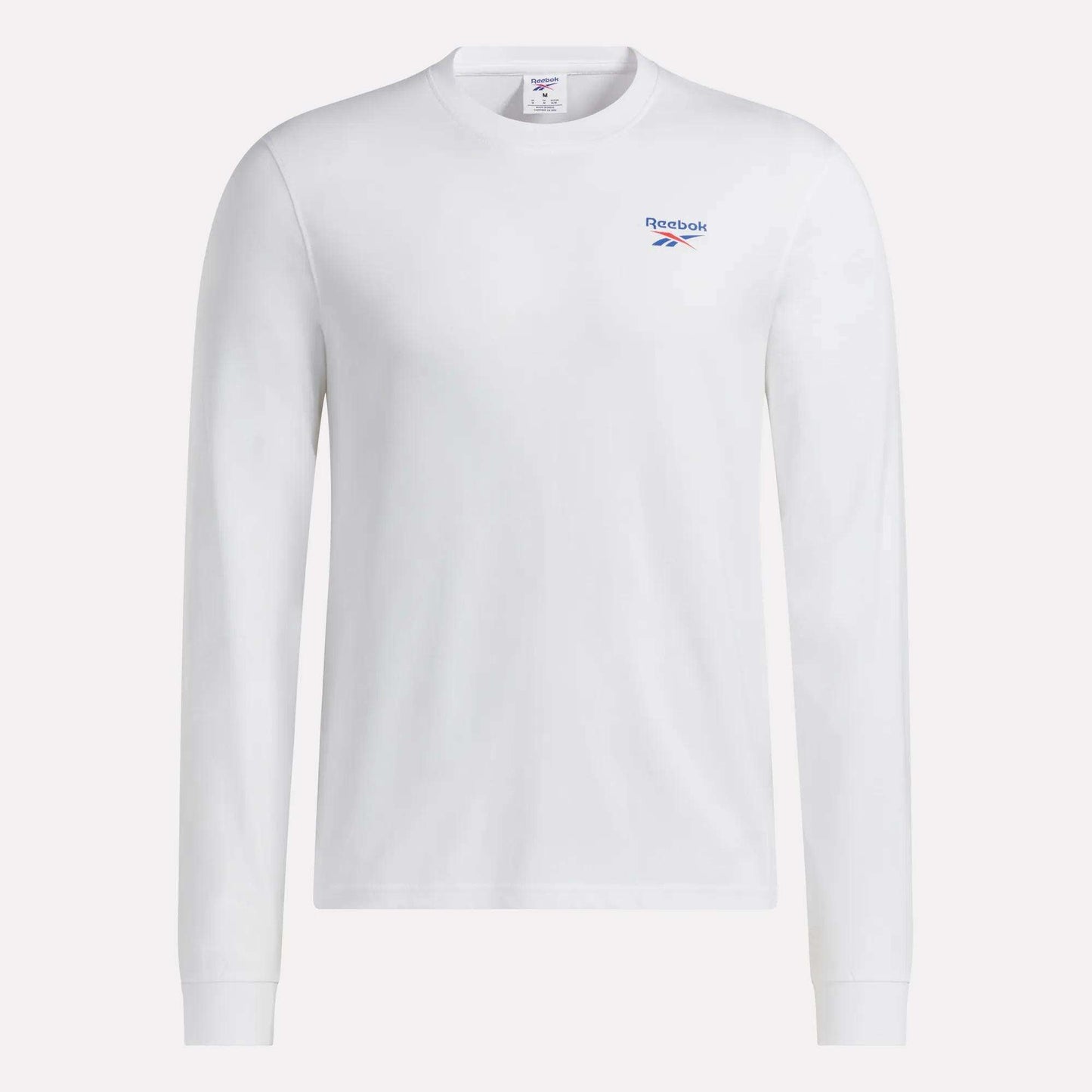 This Men's Long Sleeve T-Shirt by Reebok is made from soft cotton, featuring a comfortable crew neckline and a subtle blue Reebok logo on the left chest. Shown in plain white against a clean white background, this classic design offers timeless style.