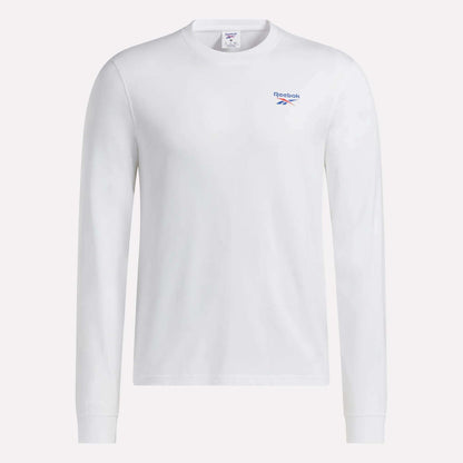 This Men's Long Sleeve T-Shirt by Reebok is made from soft cotton, featuring a comfortable crew neckline and a subtle blue Reebok logo on the left chest. Shown in plain white against a clean white background, this classic design offers timeless style.
