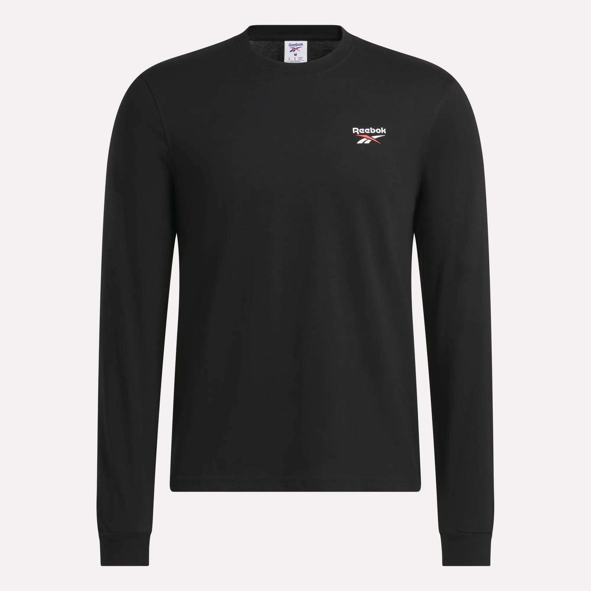 The Reebok Men's Long Sleeve T-Shirt is shown against a plain light background, featuring a classic crew neck design in black, soft cotton fabric, and a small white Reebok logo on the left chest.