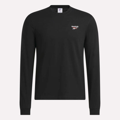 The Reebok Men's Long Sleeve T-Shirt is shown against a plain light background, featuring a classic crew neck design in black, soft cotton fabric, and a small white Reebok logo on the left chest.